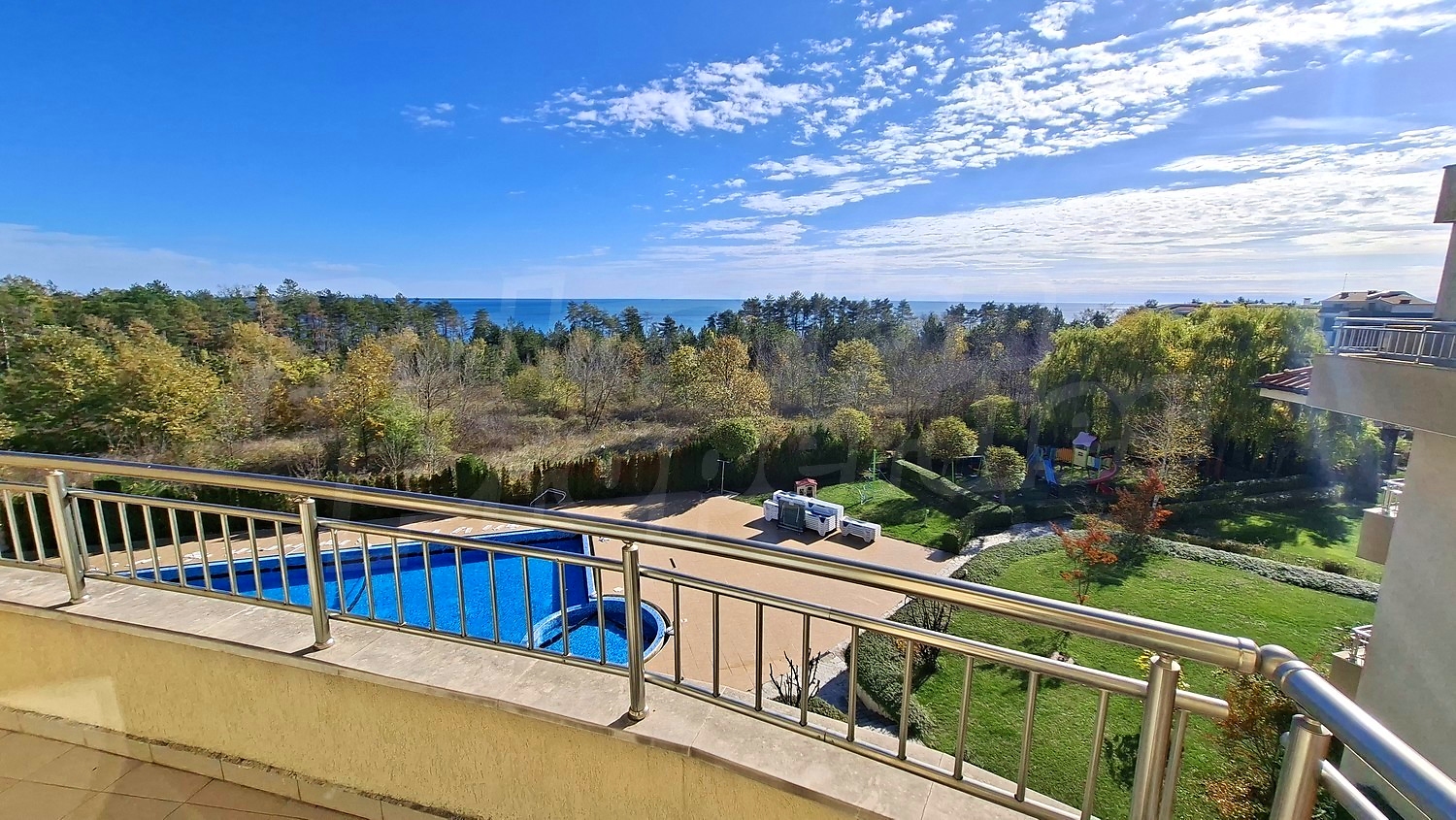 balcony, outside, view from balcony, pool, sea, green area