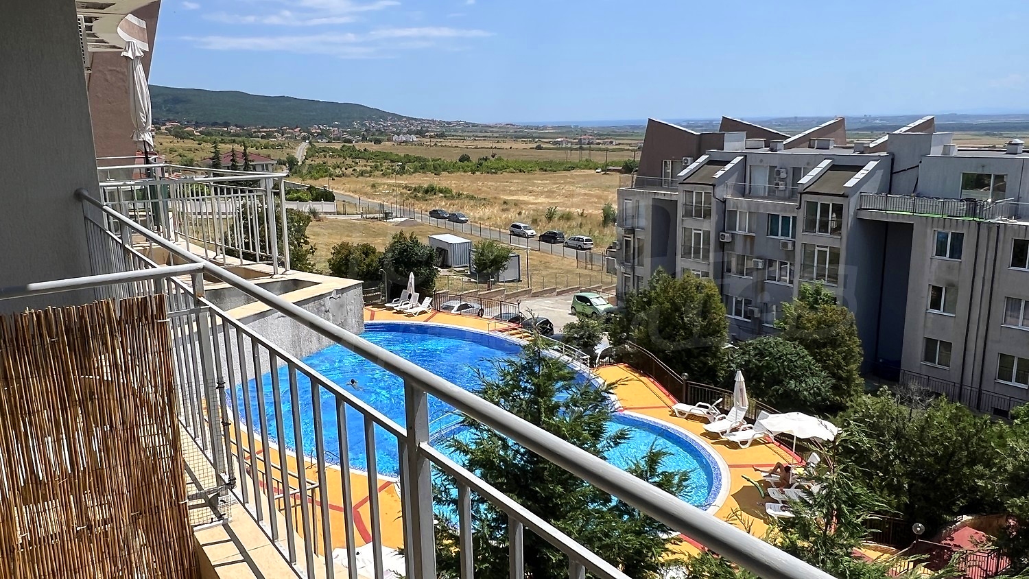 balcony, view from balcony, pool, outside, mountain, green area