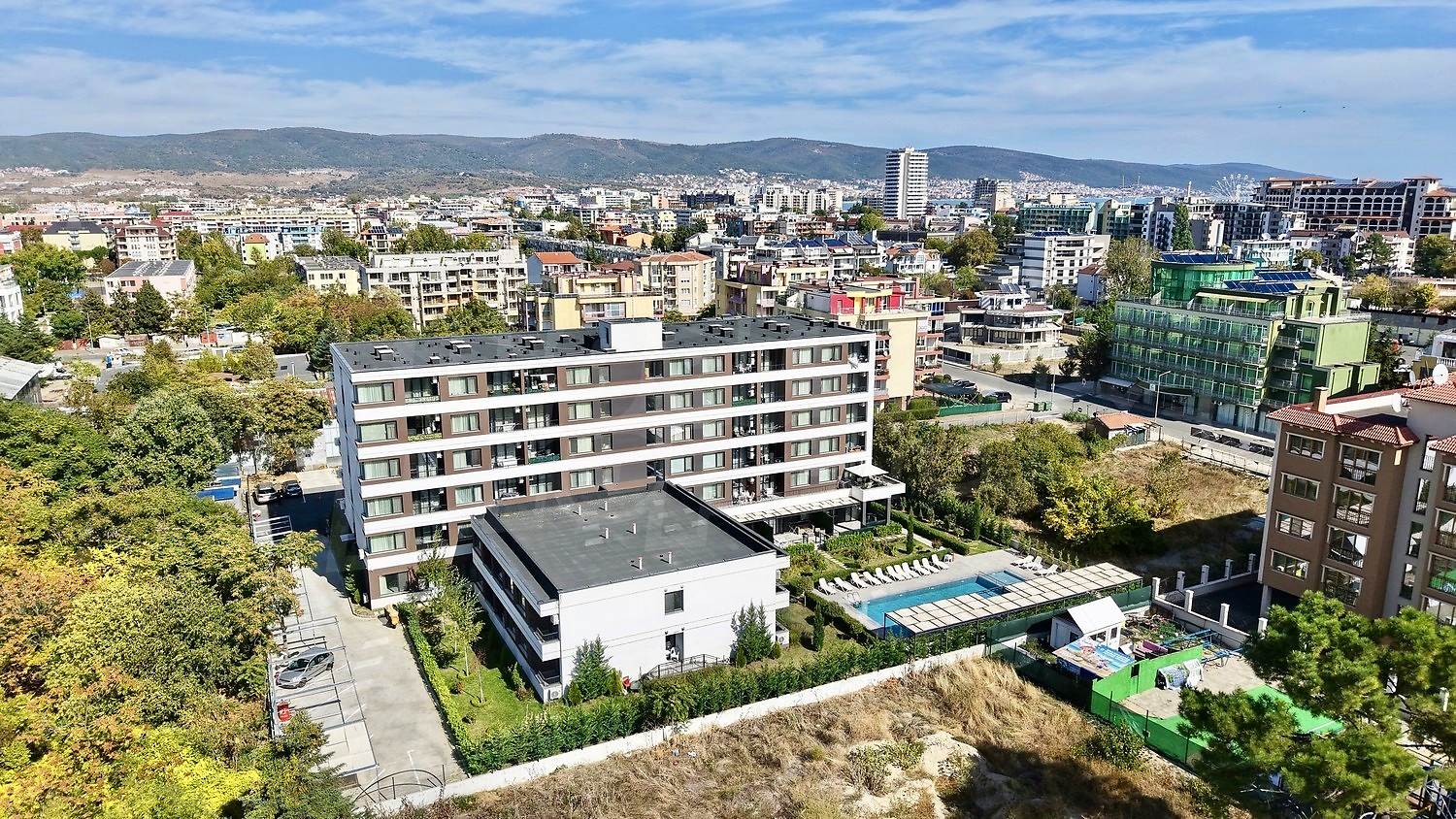 outside, facade, pool, mountain, view from balcony, parking, garden