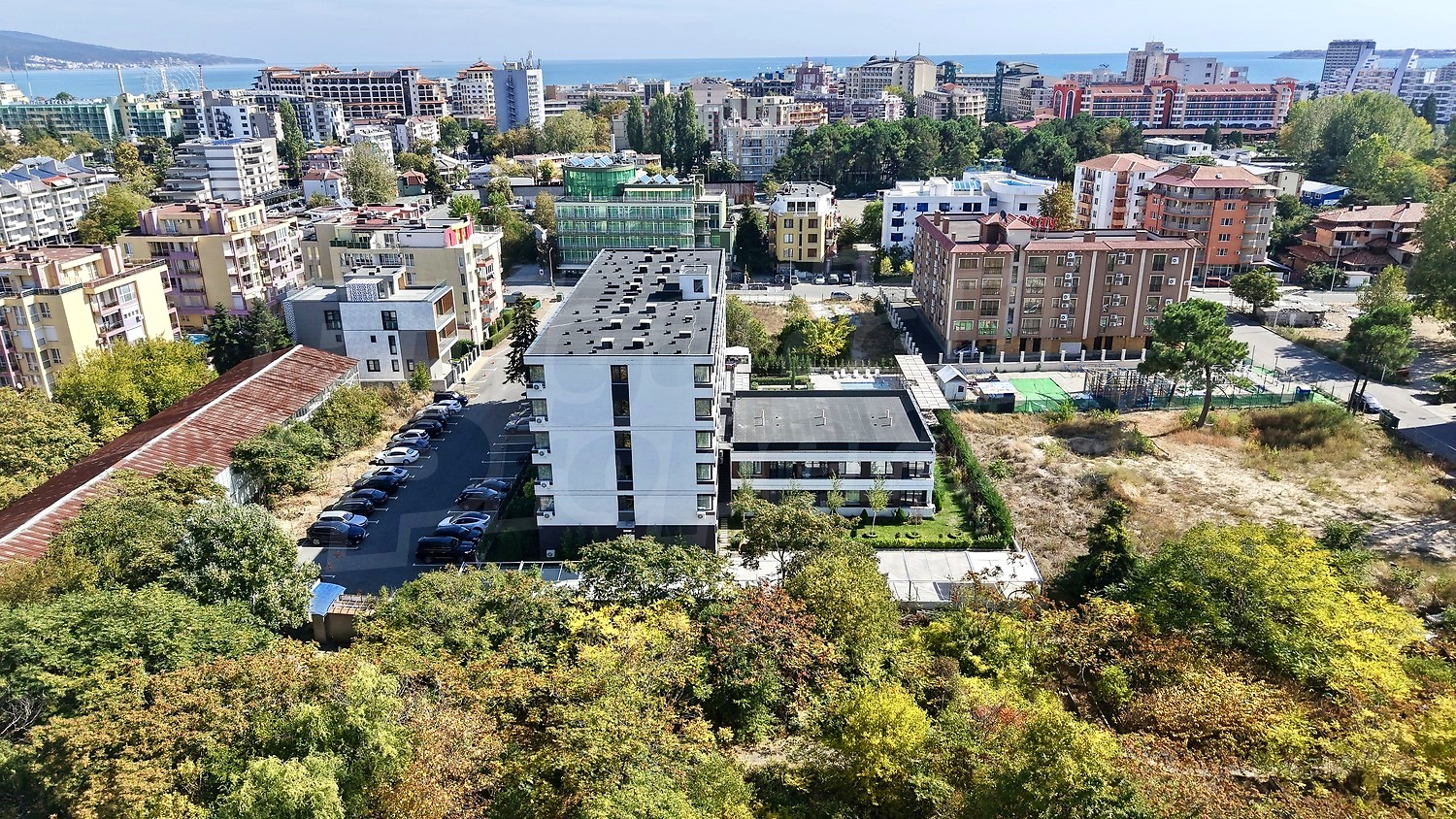 outside, view from balcony, green area, parking, sea