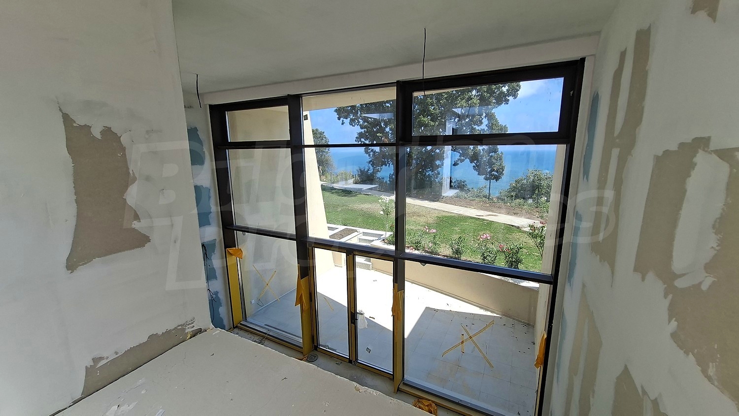 inside, view from balcony, sea, green area