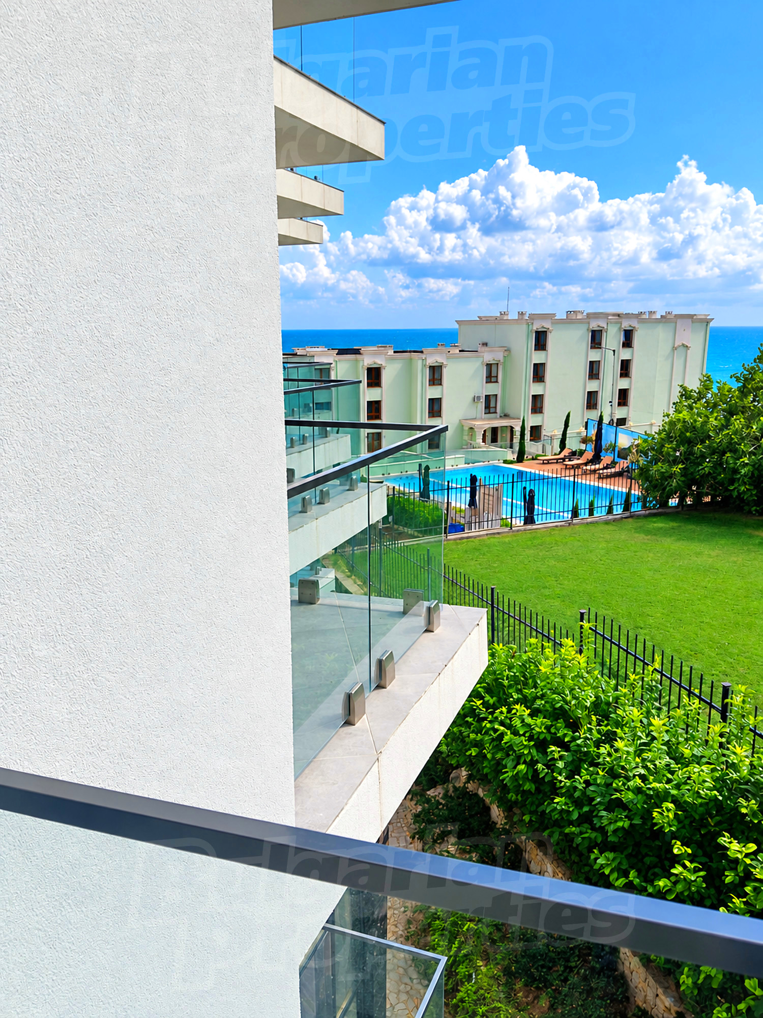 outside, view from balcony, pool, sea, green area