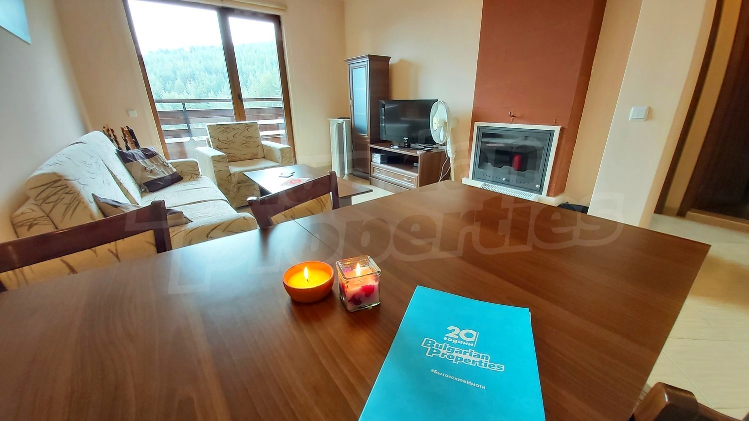 inside, living room, fireplace, furnished, view from balcony