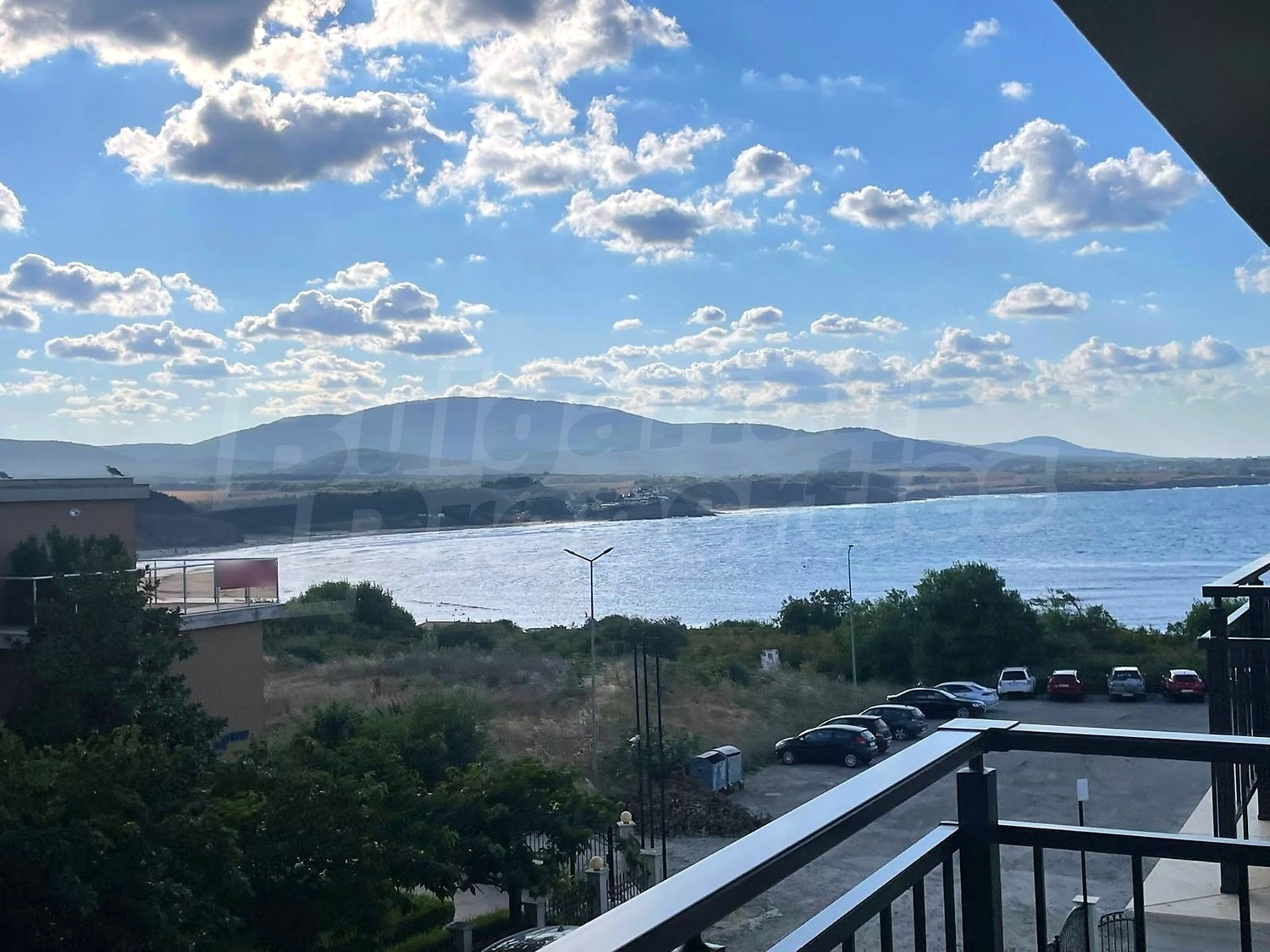 outside, view from balcony, sea, mountain, parking