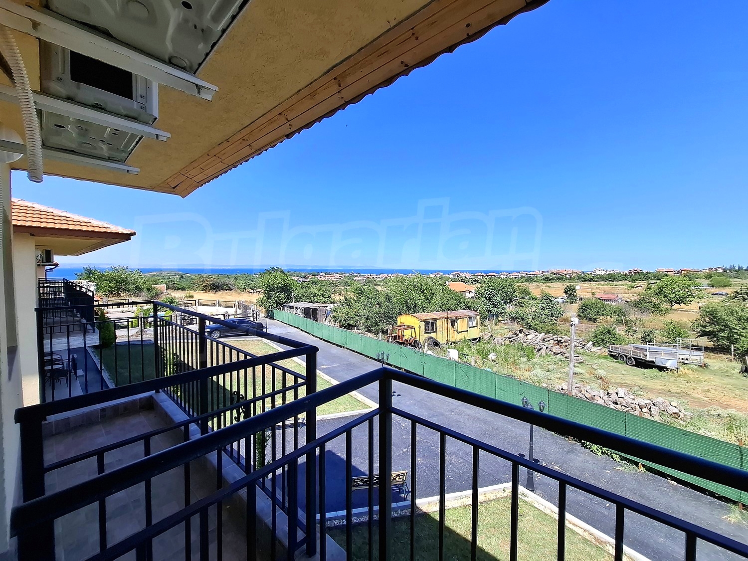 balcony, outside, view from balcony, sea, green area
