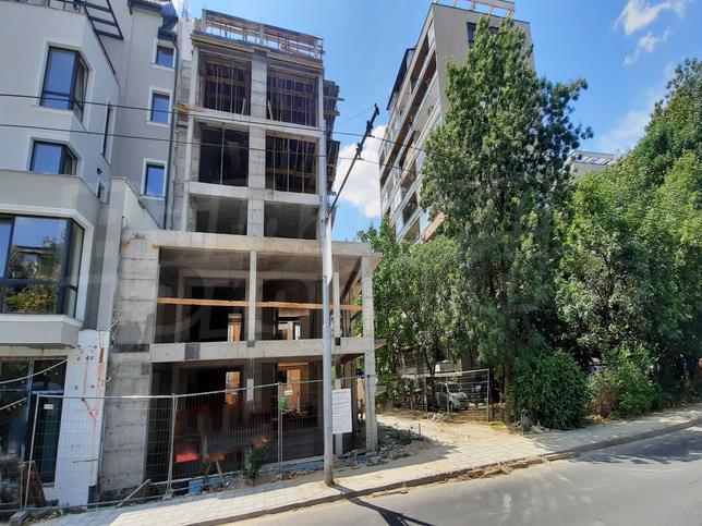 Modern residential building with apartments, two-level office, shop, parking spaces and garages Modern residential building with apartments, two-level office, shop, parking spaces and garages