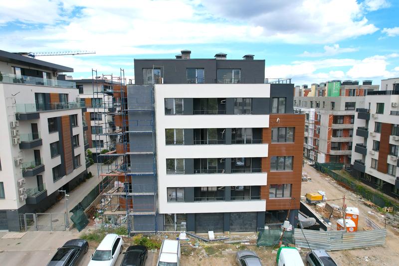 Complex of three multi-family residential buildings with garages and parking spaces Complex of three multi-family residential buildings with garages and parking spaces