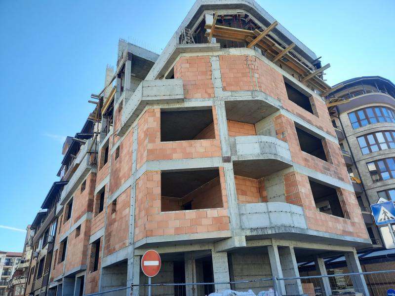 New building under construction near the center of the seaside town New building under construction near the center of the seaside town