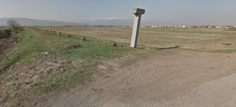 Flat and rectangular plot facing an asphalt road in developing area