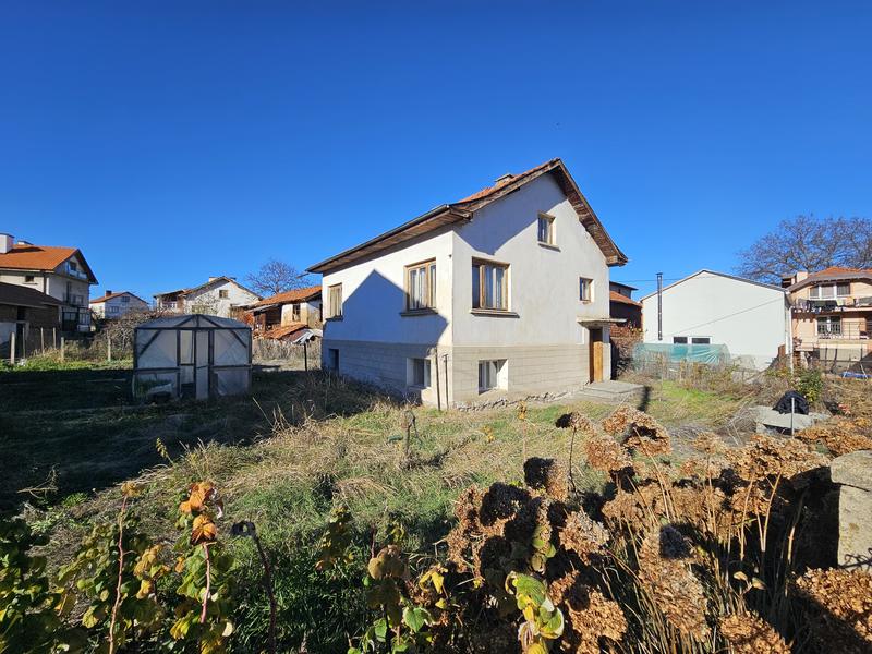 Property with potential next to the central square of Dospey village