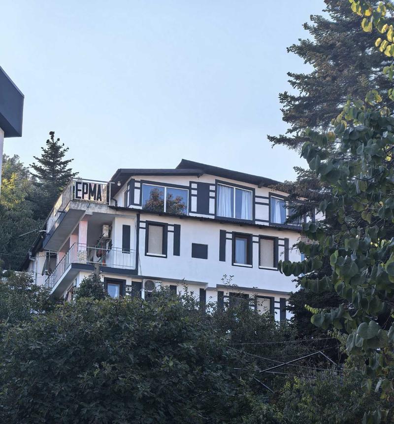 Established four-storey business property with sea views, furnished accommodation units and a garden